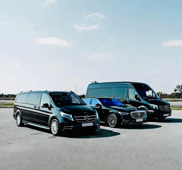 Mercedes V-Class, S-Class and an executive van lined up on an airfield for Royale Rides chauffeur services