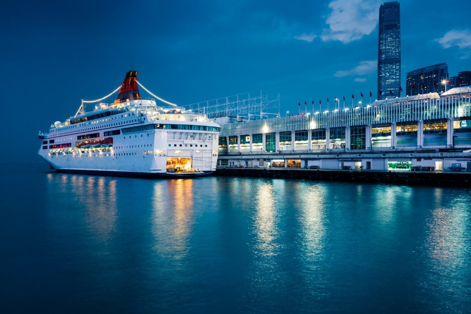 Cruise ship docked at port at night for a cruise terminal chauffeur transfer