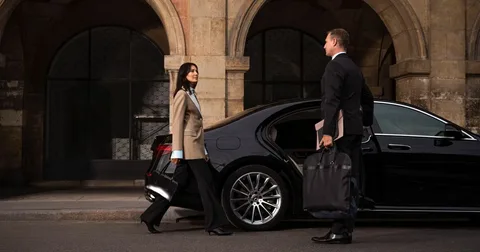 Professional chauffeur in business attire representing corporate chauffeur service in Altrincham