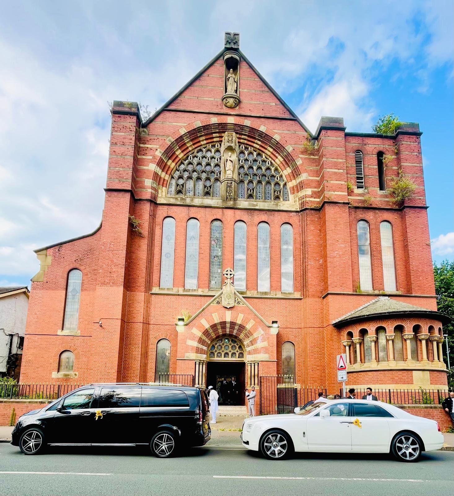 Royale Rides Mercedes V Class and Rolls Royce wedding cars parked outside a church venue for a luxury wedding booking.