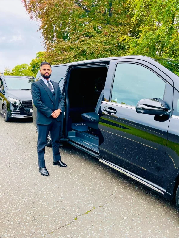 Royale Rides chauffeur opening a Mercedes V Class sliding door for a Wilmslow collection