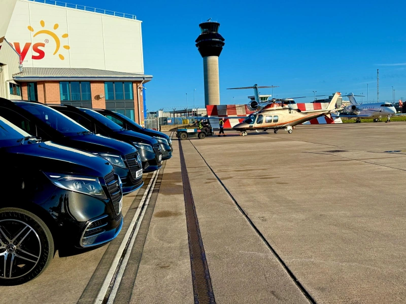 Royale Rides chauffeur vehicles waiting on the airfield for a private aviation transfer