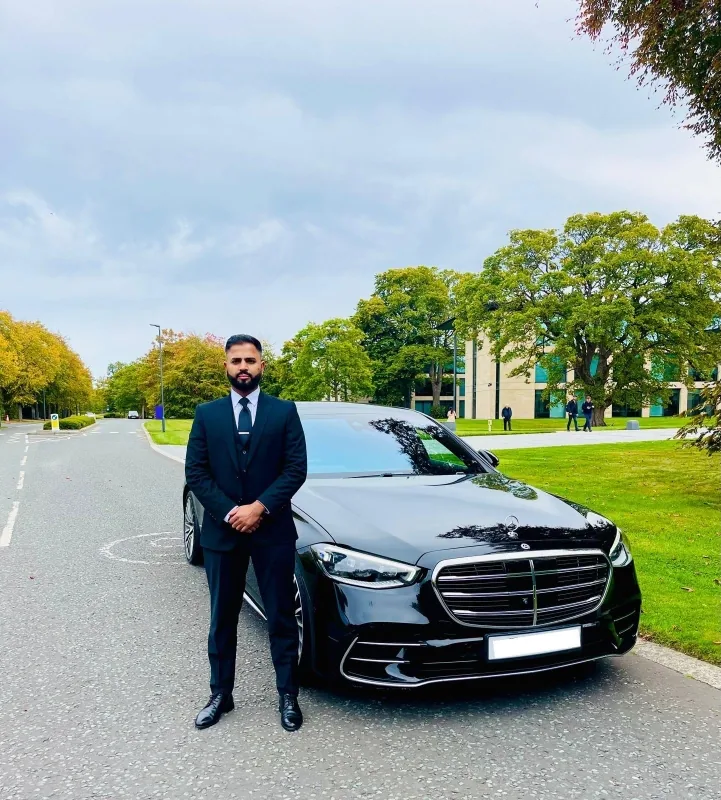 Royale Rides professional chauffeur beside a Mercedes S Class in Wilmslow