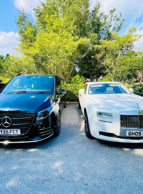 Black Mercedes and white Rolls-Royce Ghost wedding car pair at a Manchester venue
