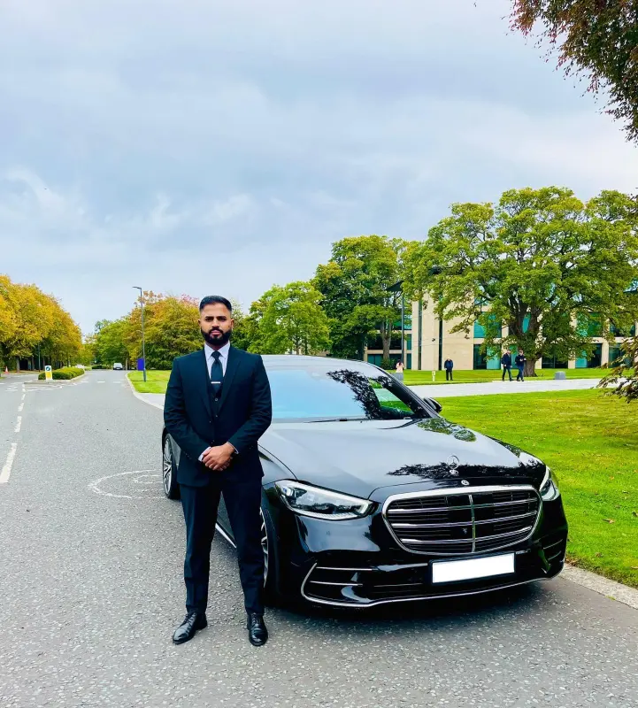 Royale Rides chauffeur standing beside a Mercedes S-Class before a long distance journey
