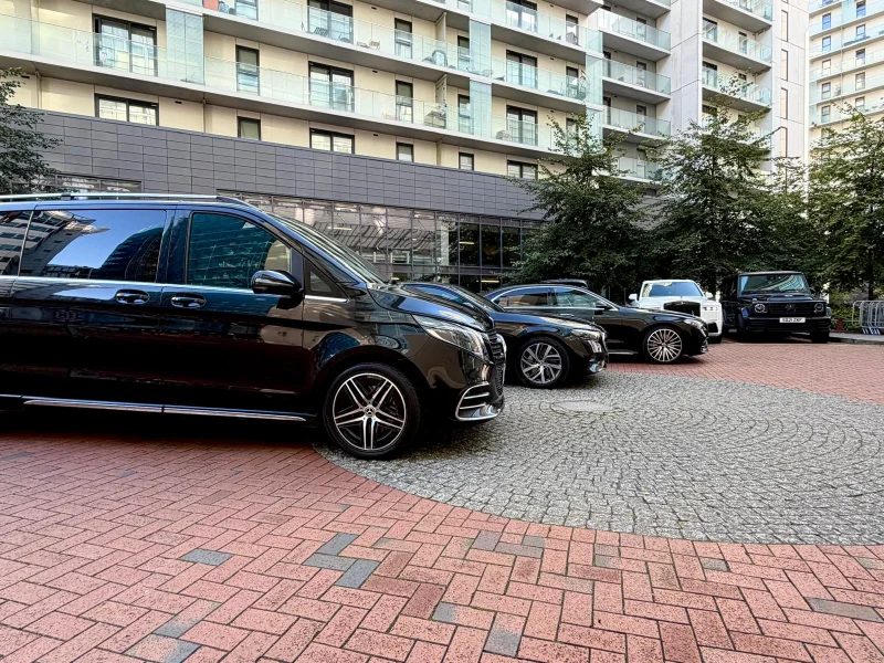 Black Mercedes V-Class chauffeur vehicle on a brick forecourt in Oldham