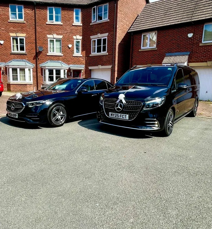 Mercedes wedding cars dressed with white ribbons outside a Manchester home